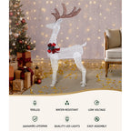Lighted white reindeer decoration with red bow and glittering LEDs, full-body standing