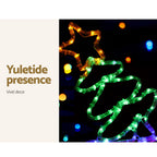 Glowing multi-color LED train Christmas decoration with swirling green and gold lights