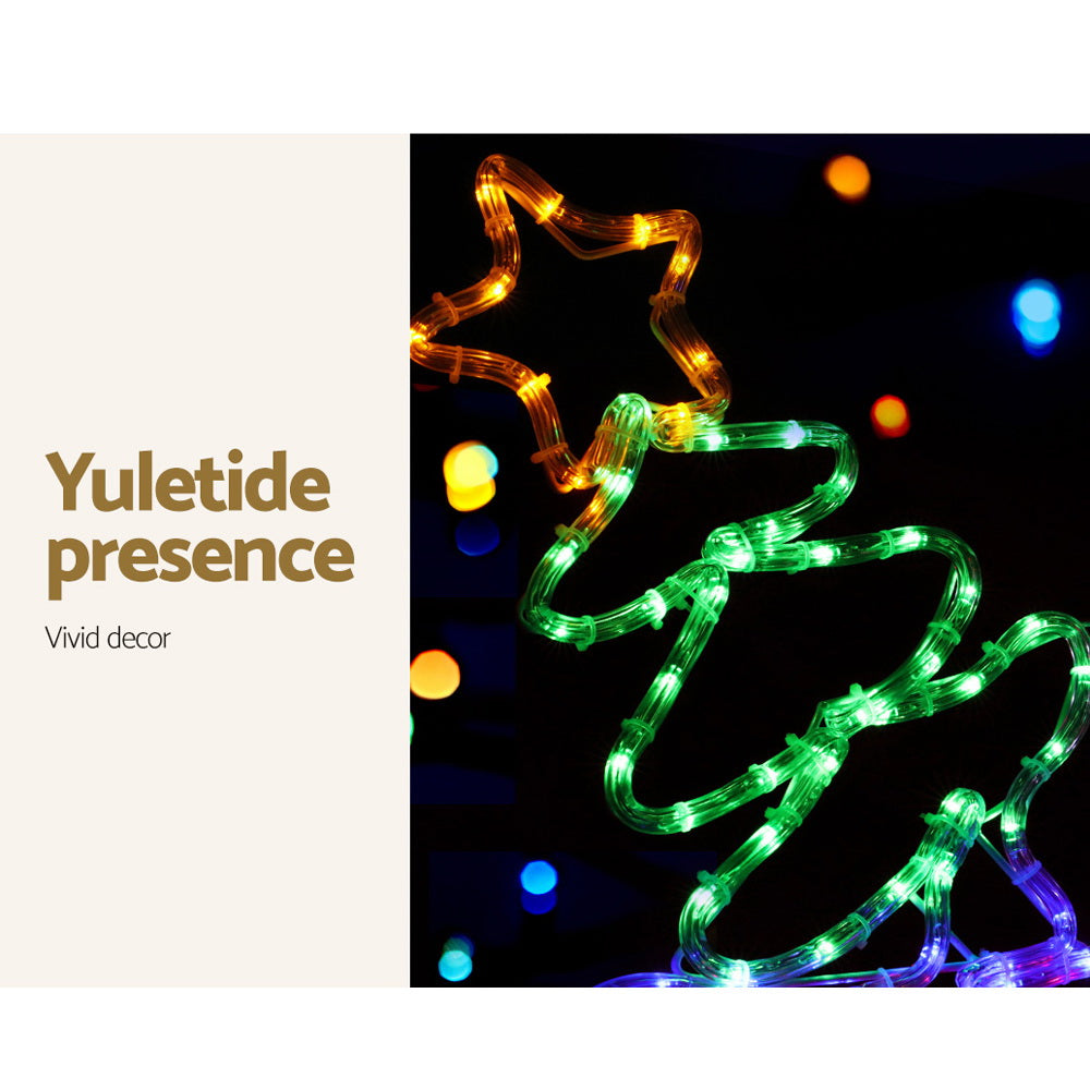Glowing multi-color LED train Christmas decoration with swirling green and gold lights