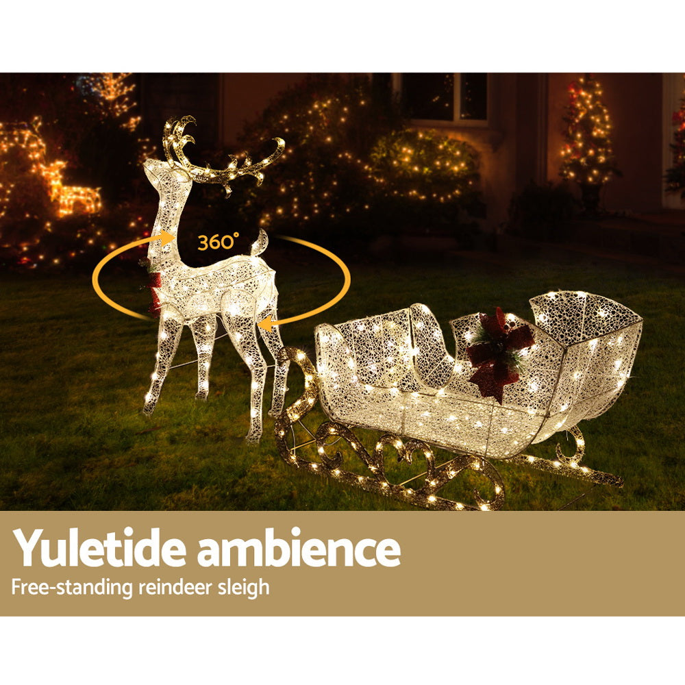 Warm-lit reindeer and sleigh outdoor decoration with 360-degree glowing ring and red bows