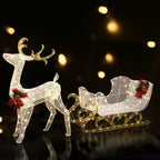 Warm LED-lit white reindeer pulling gold sleigh with red bow accents