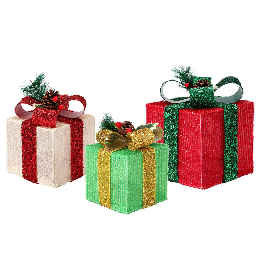 Set of three Christmas fabric gift boxes with warm white light glow