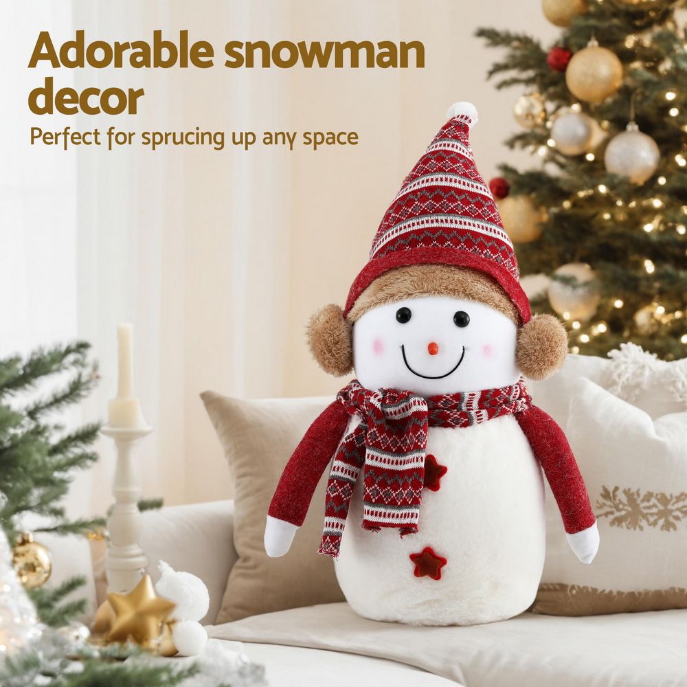 Plush snowman in red and white with knit hat, red scarf, and star-shaped accents