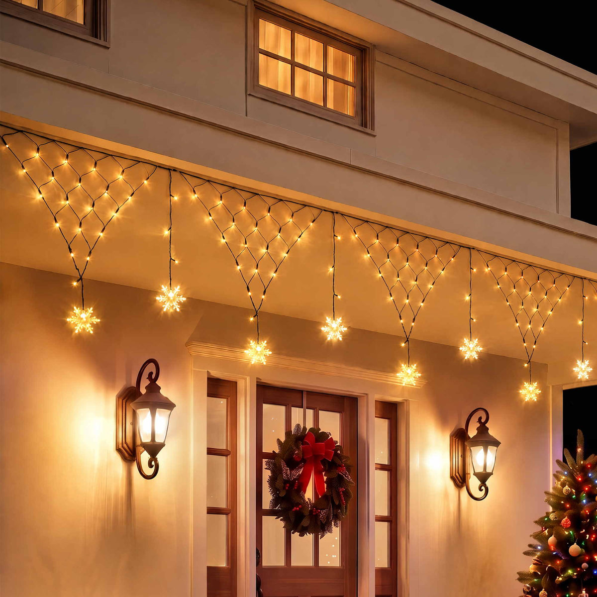 Solar warm white Christmas fairy net lights with snowflake bulb design along a house eave